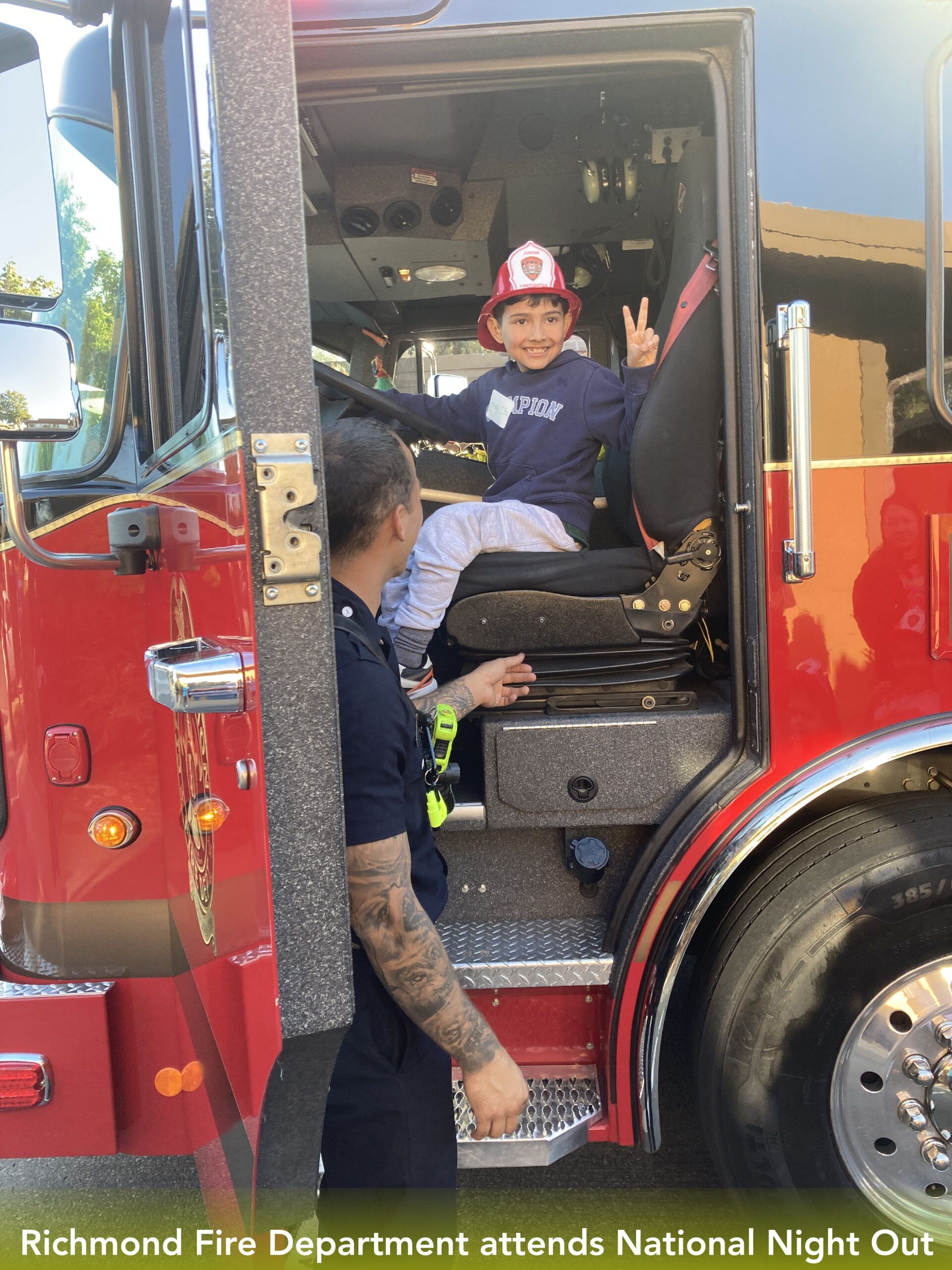 Richmond Fire Department attends National Night Out. RCD resident sits in their firetruck